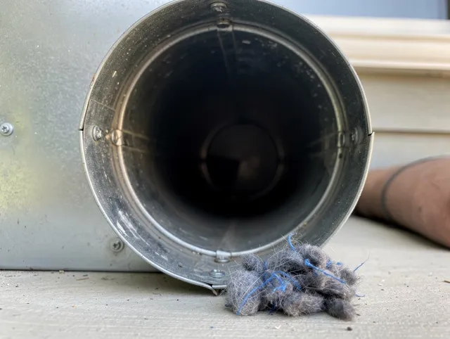 Daytona Beach Dryer Vent Cleaning technician using specialized equipment to clear severe dryer vent blockage in Daytona Beach